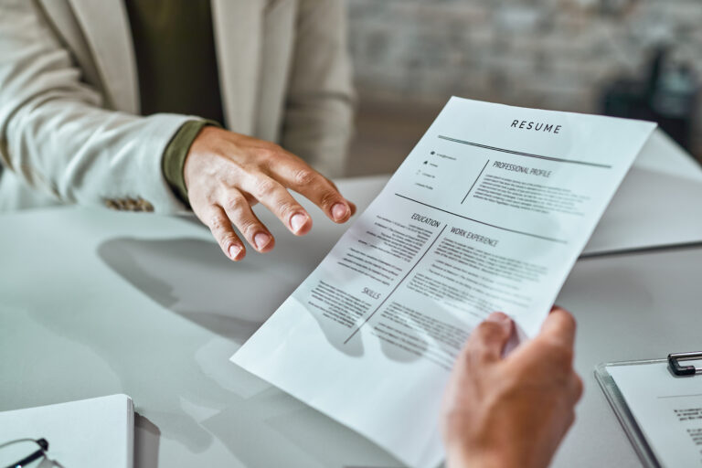 An employee handing his resume to empoyer